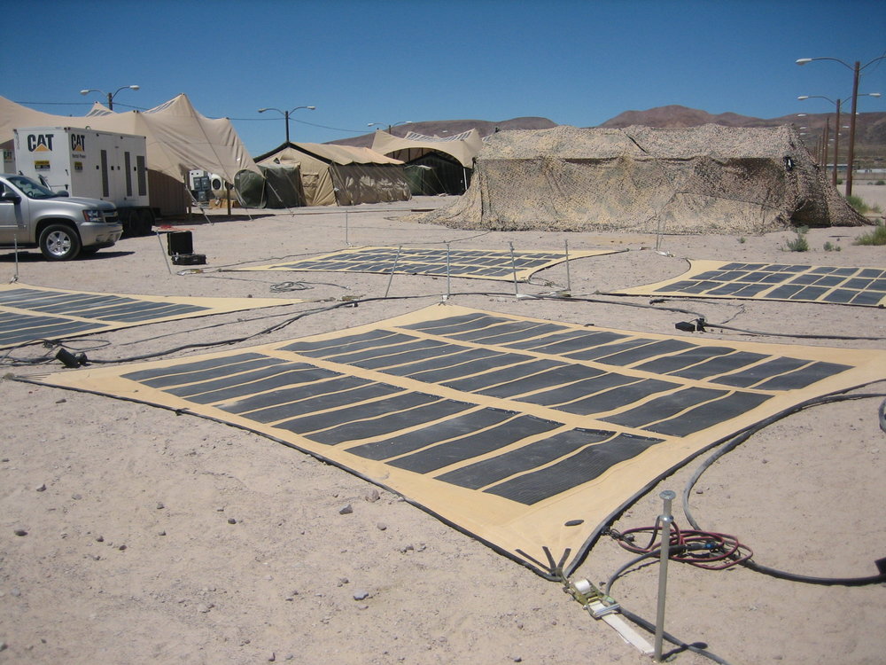 One of Pvilion's flexible, military solar canopies set up on the ground, generating energy — ESG