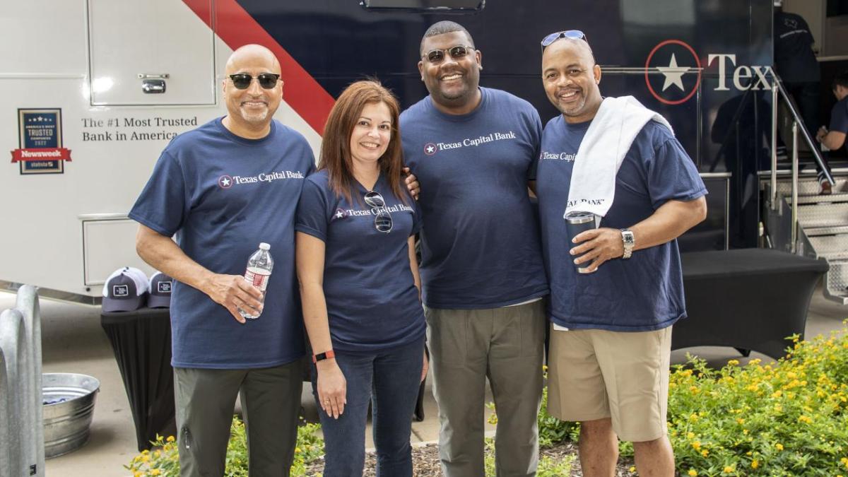 group at event all wearing Texas Capital Bank Tshirts