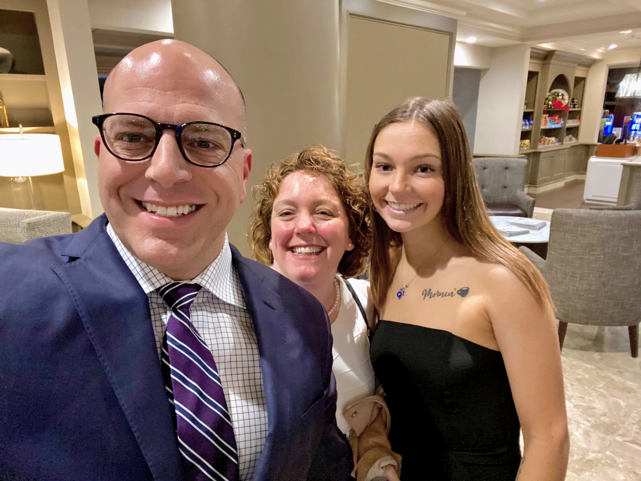 Scott, his wife and daughter taking a 'selfie' in a lobby