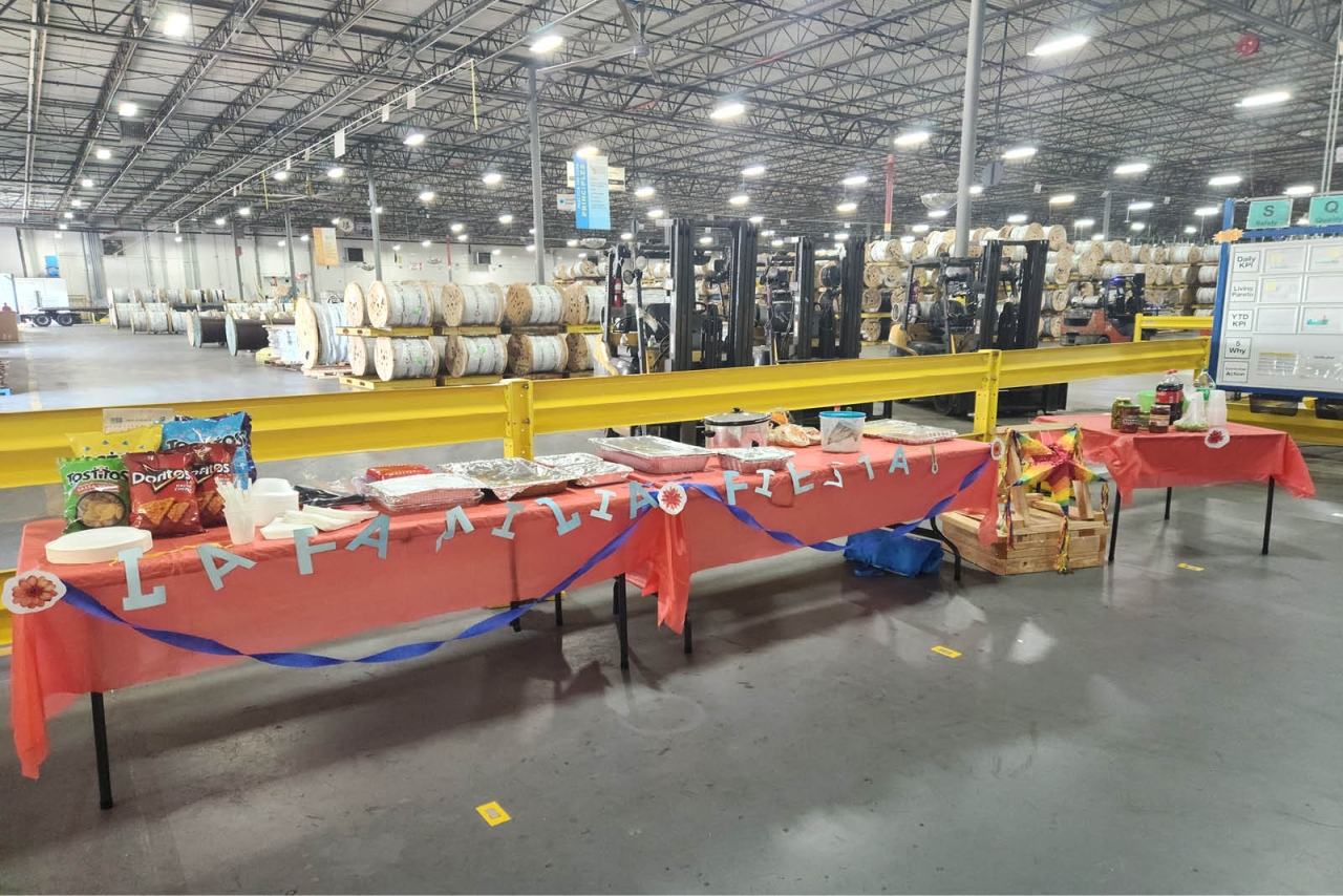 Tables decorated and food set up at the entrance to a large warehouse