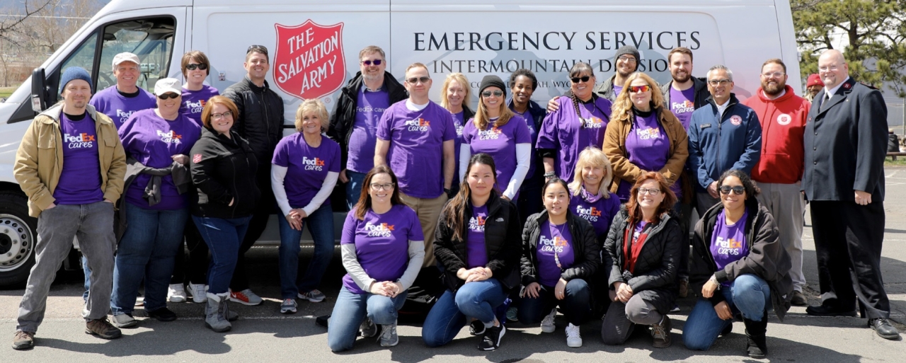 FedEx volunteers in front of a Salvation Army van