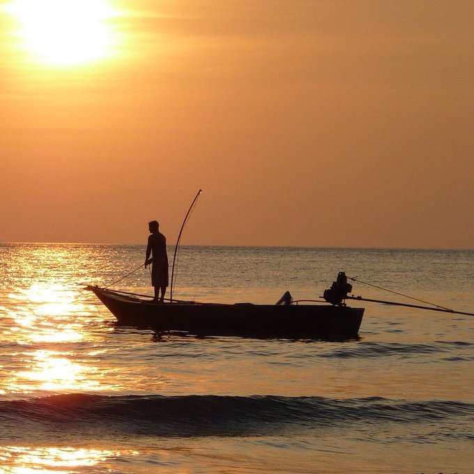 fishing in a boat at sunrise