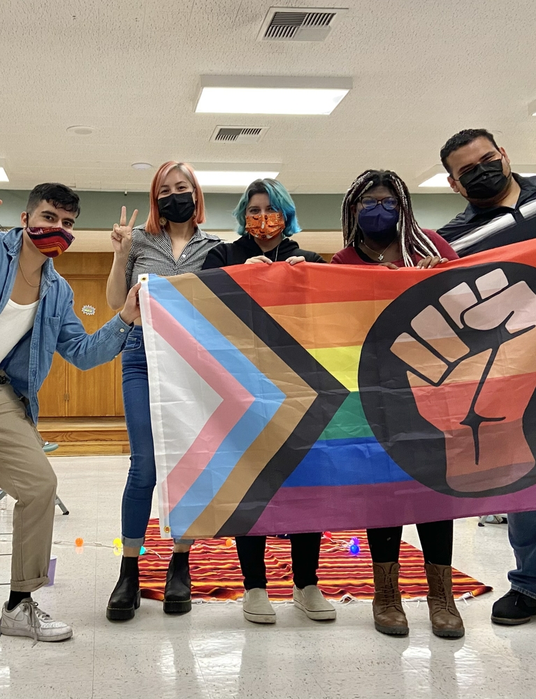 Latino Equity Alliance group with a LGBTQ+ flag