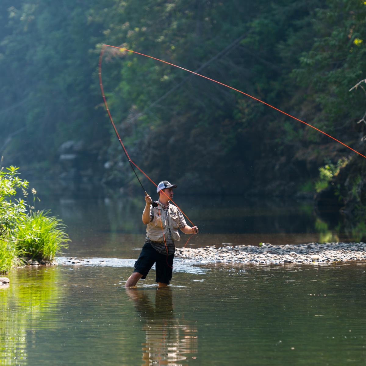 A person in a stream fly-fishing.