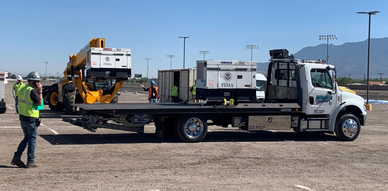 a truck/trailer being loaded with a generator