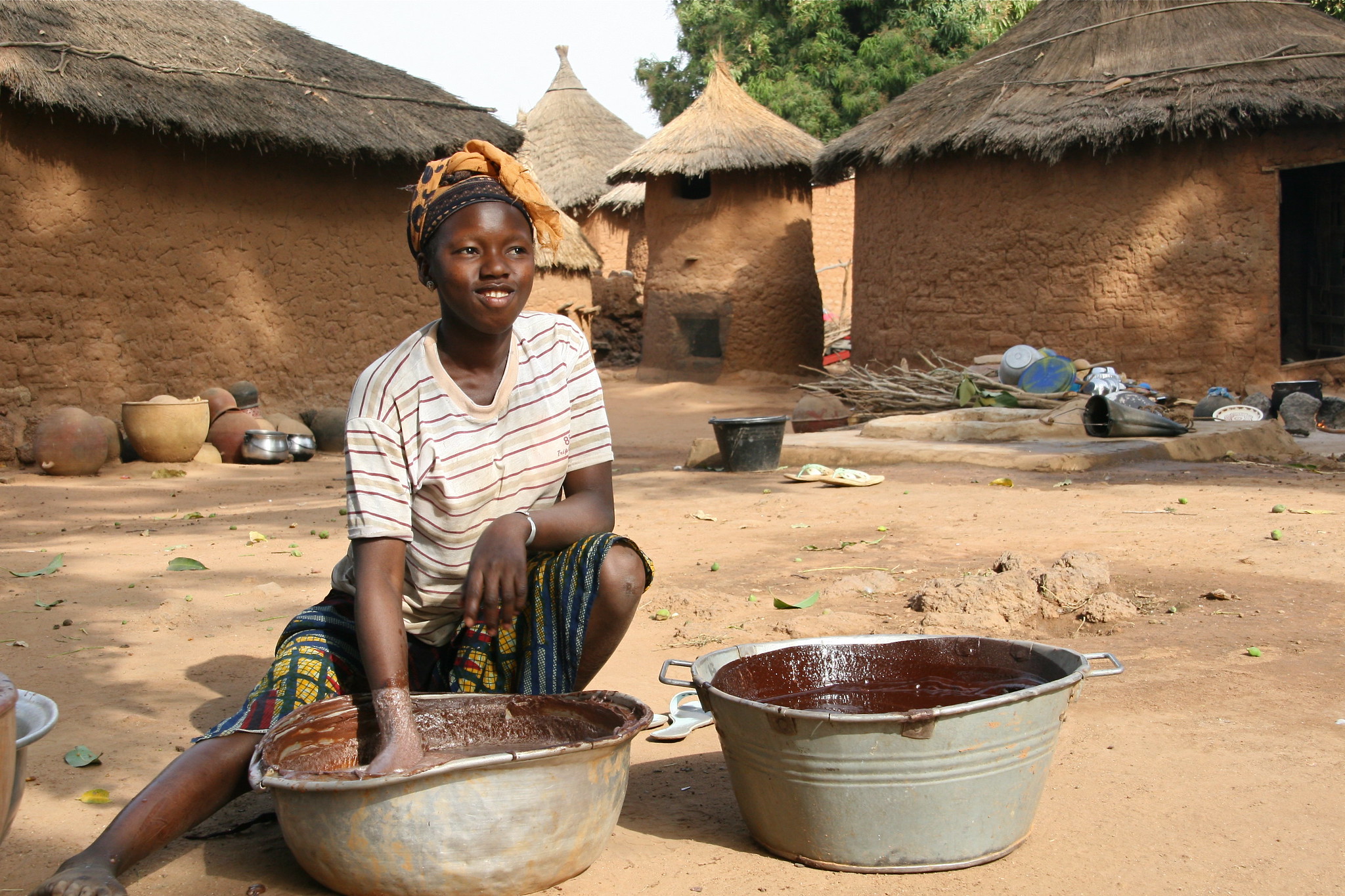 girl processing cacao in west africa - how to address child labor in cacao