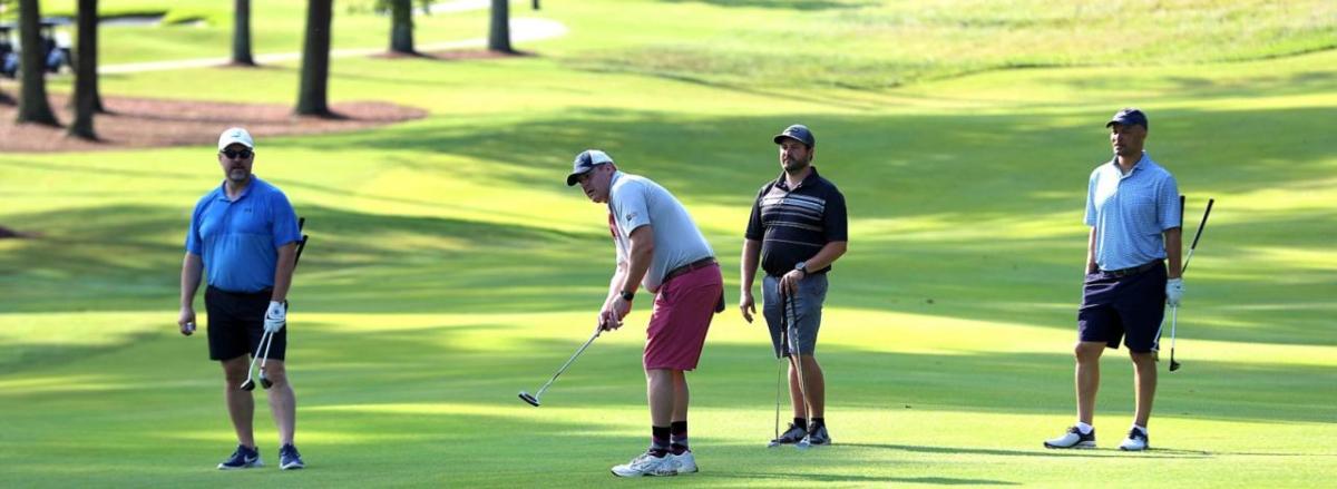 Four golfers on the course.