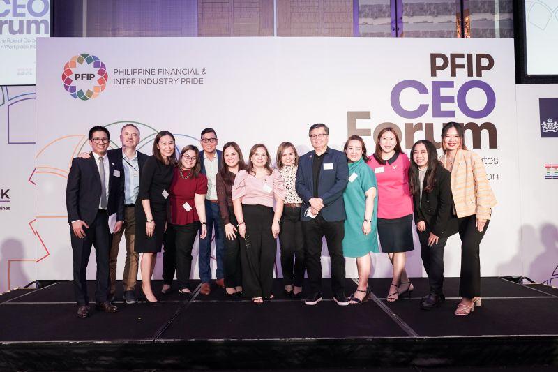 A group of people posed for the camera. Large "PFIP CEO Forum" sign behind them.