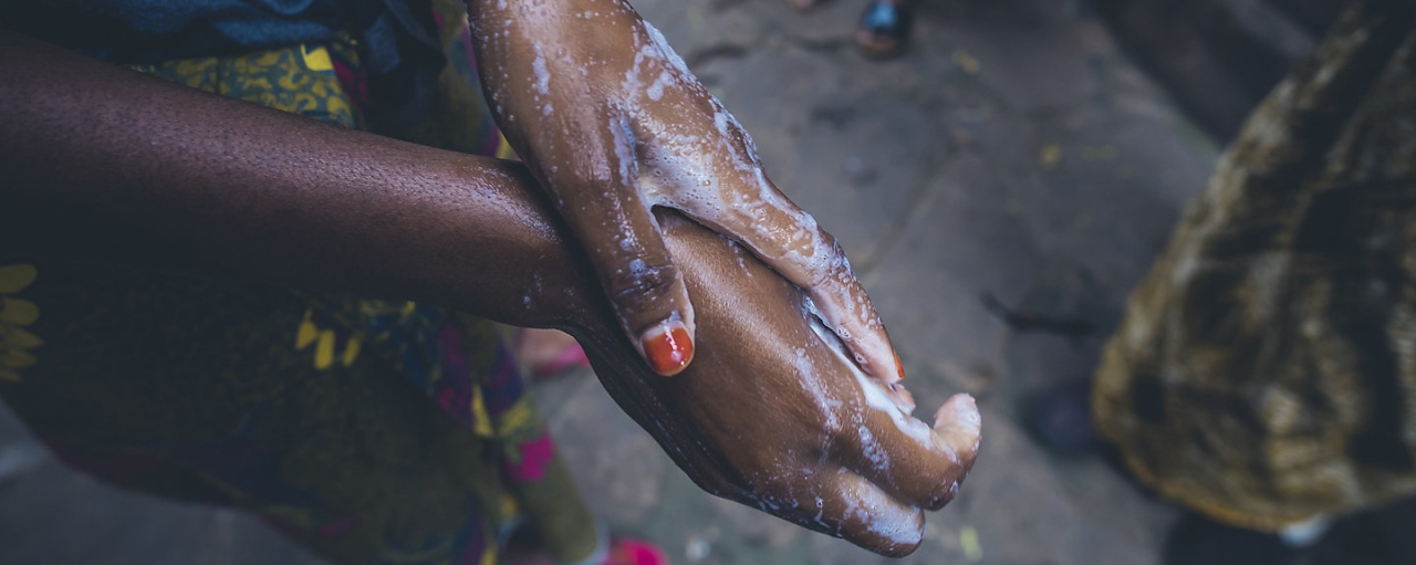 hands being washed with soap and water