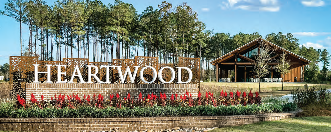 An outdoor sign "Heartwood" and a home in the distance.