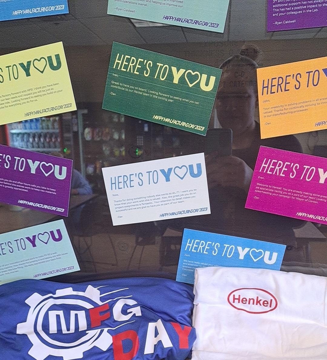 Colorful "Here's to you" signs on a window.