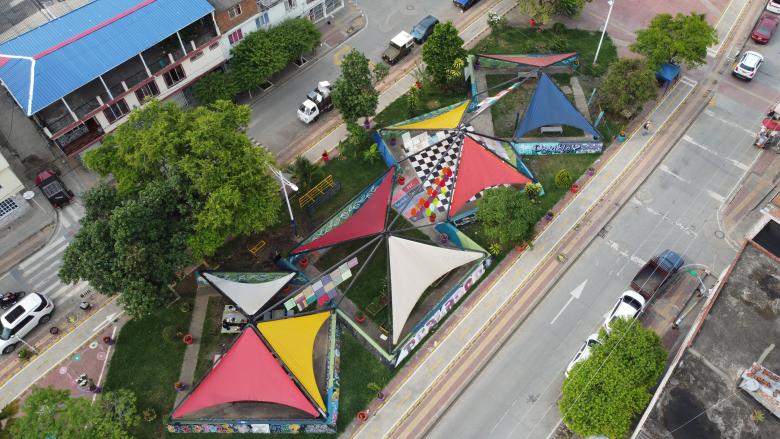 aerial view of colorful triangular tent roofs in between two streets
