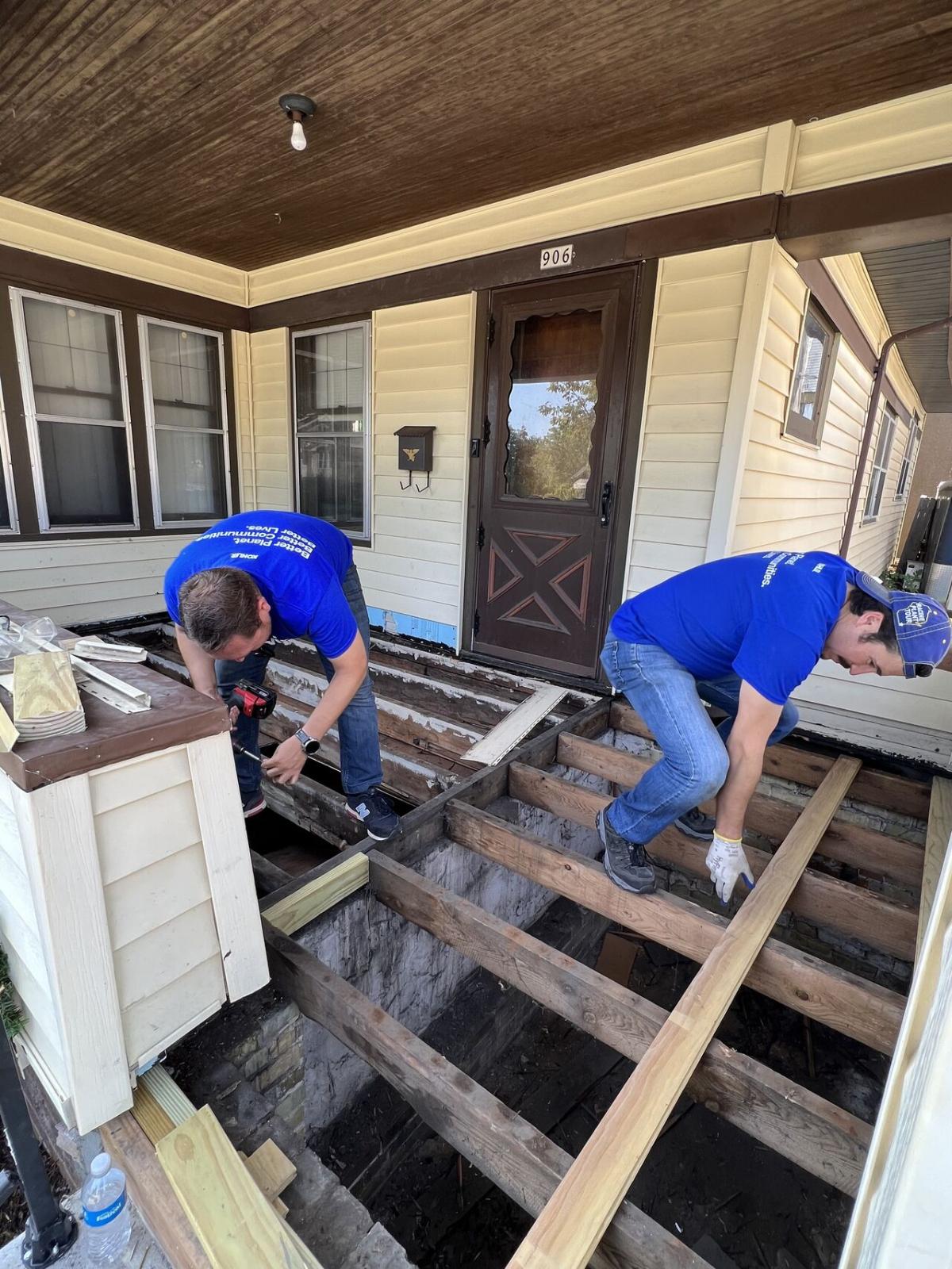 volunteers repairing a house porch