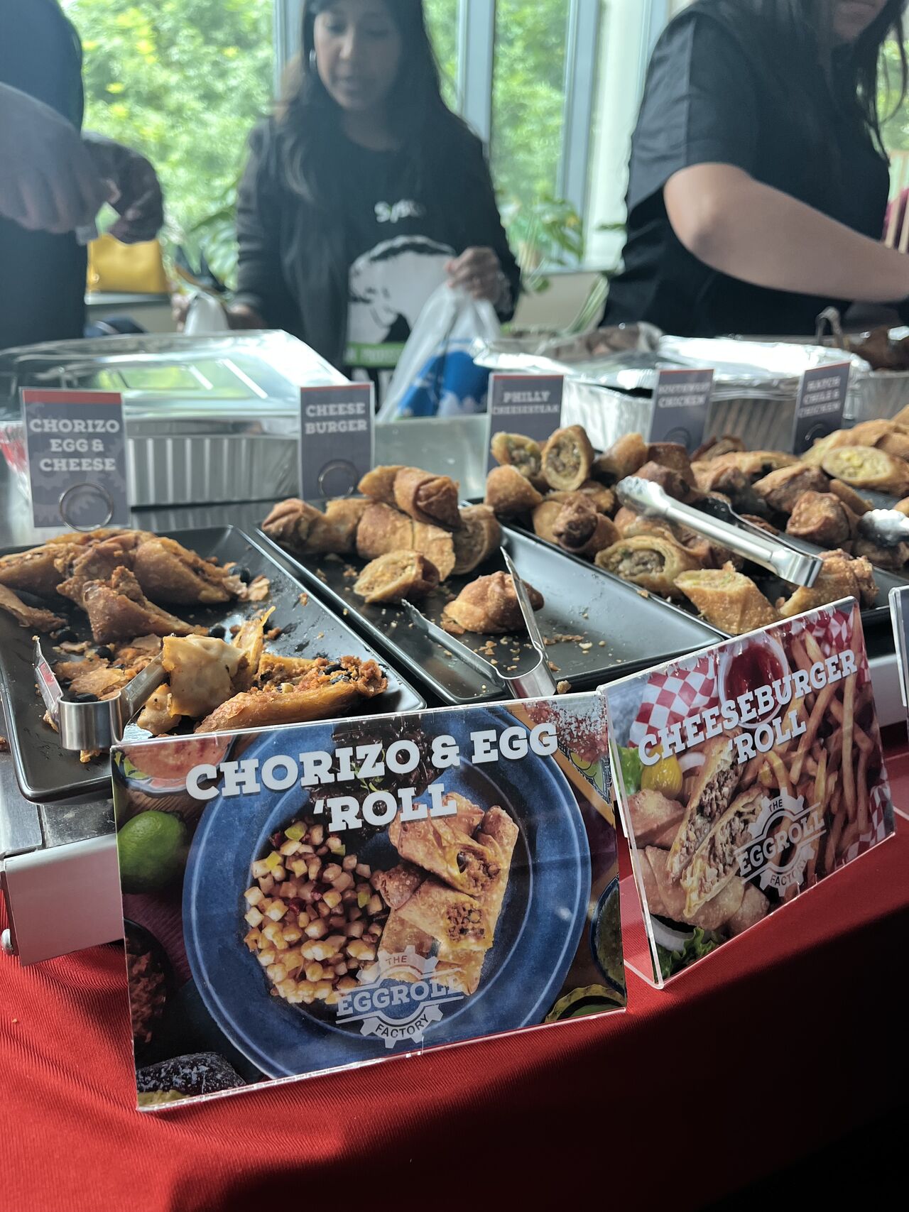 Various foods in metal trays on a table