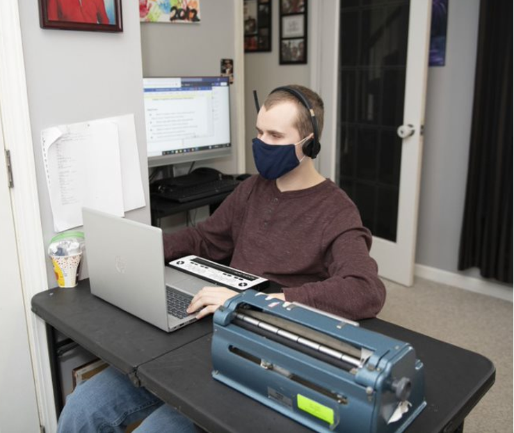 (In the photo above, Dylan uses his donated HP laptop, external monitor, and headset to do his lessons from home. He also has a school-issued Braille display and Brailler to use.)