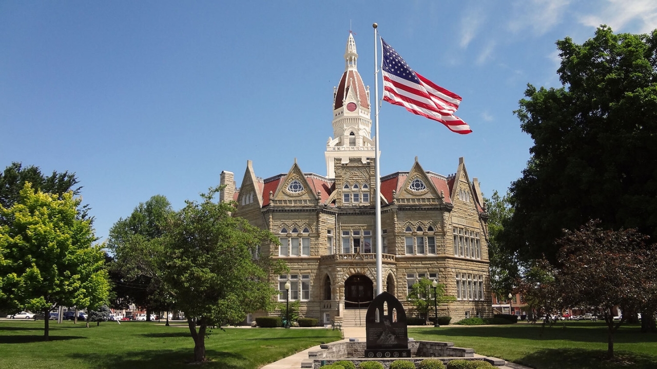 American flag in front of a large stone building