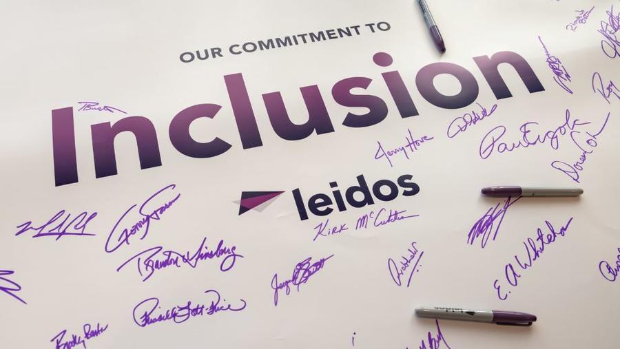 Signed poster that reads " Our Commitment to Inclusion, Leidos"