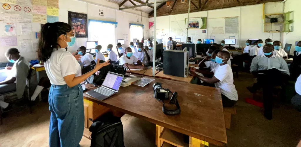 Kavya Krishna teaching a classroom of students each sitting with a computer.