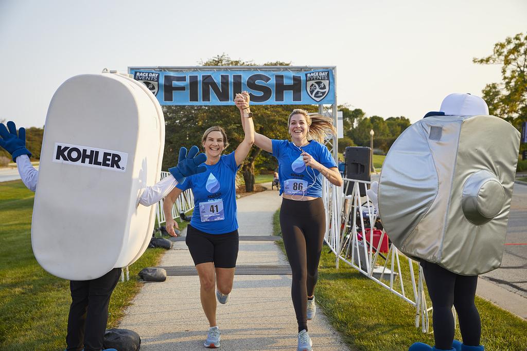 2 people celebrate crossing the finish line