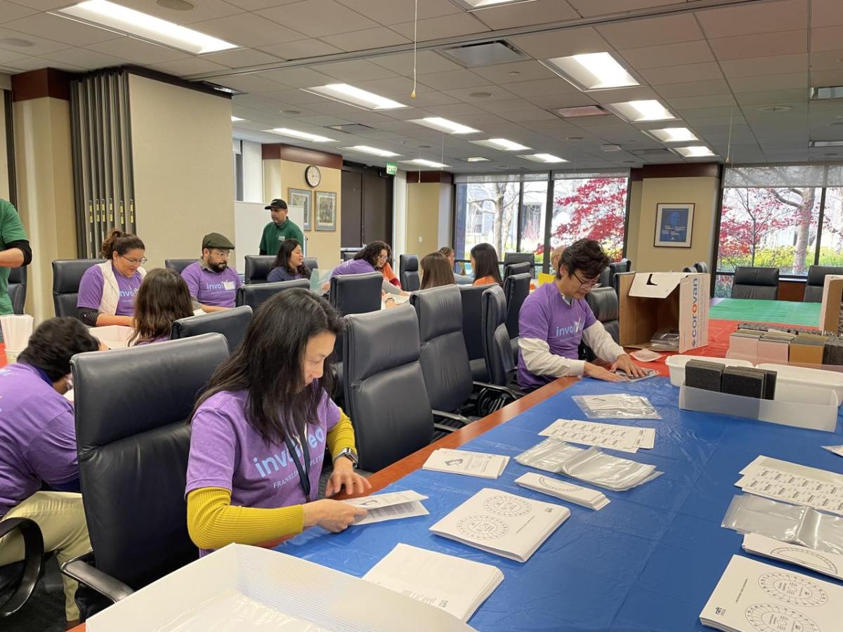 person stuffing envelopes