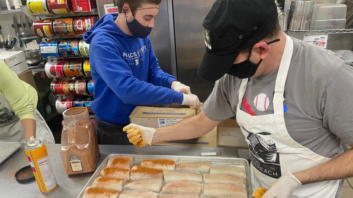 Volunteers prepping fish to cook