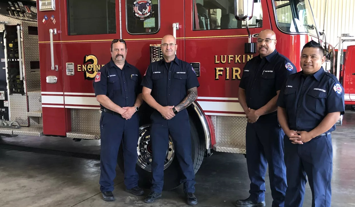 four firefighters and a firetruck