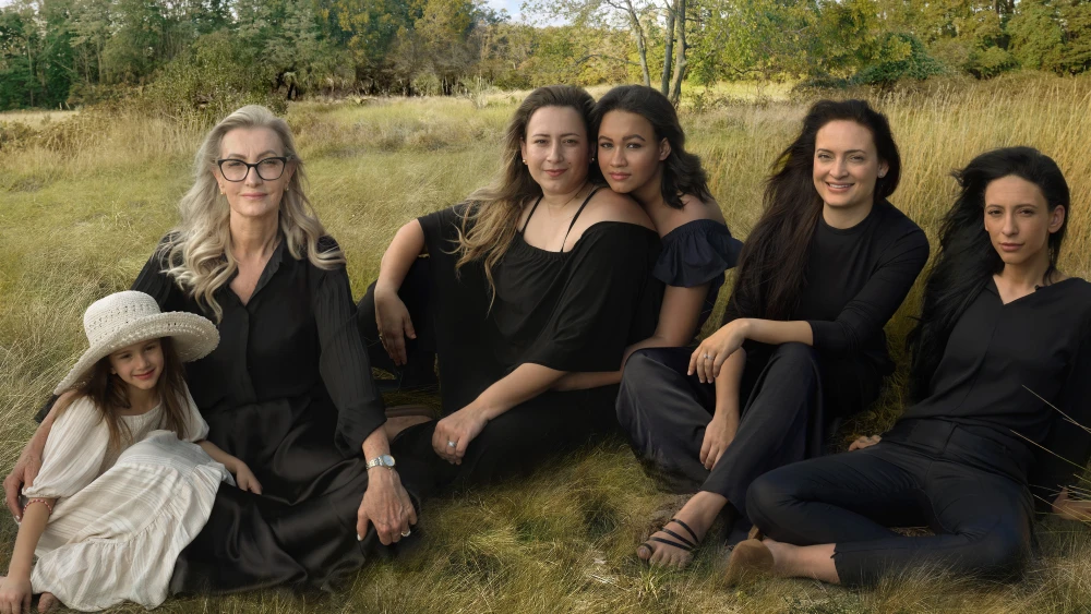 Women on sitting on the ground dressed in black