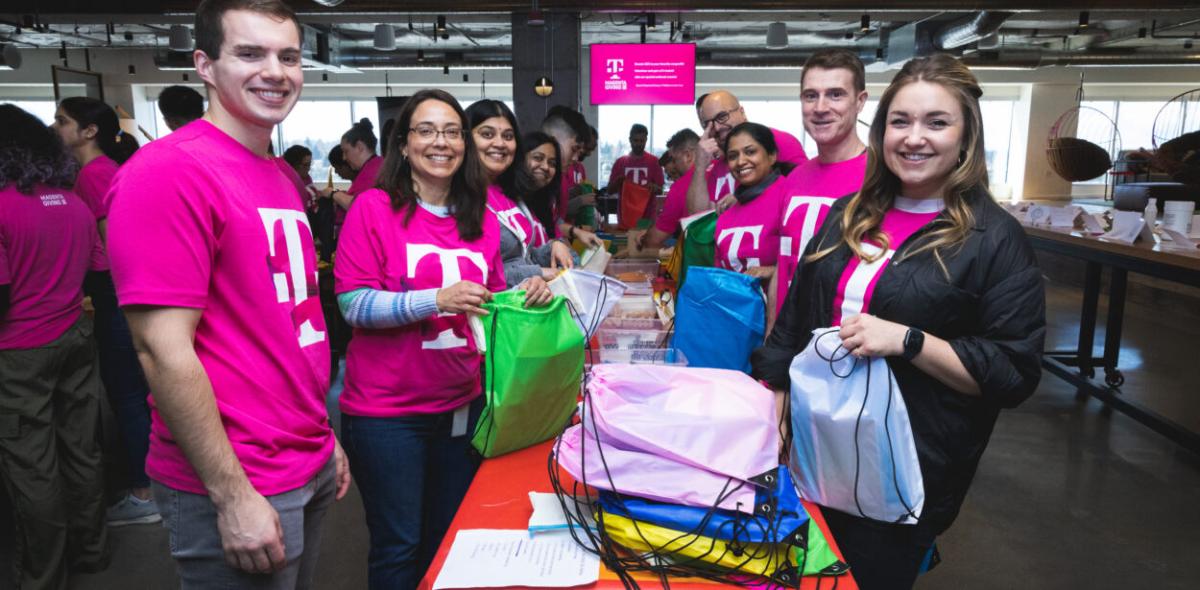 Volunteers packing colorful bags in two lines.