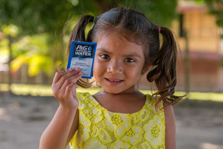 Child holding water packtet