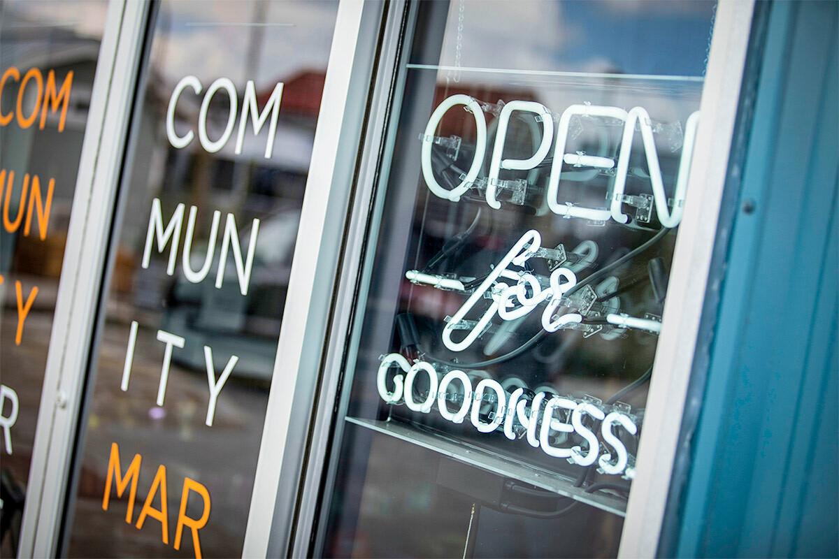 Exterior of "Community Market" a sign "Open for goodness".