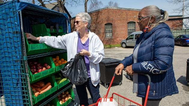 People choosing produce outside