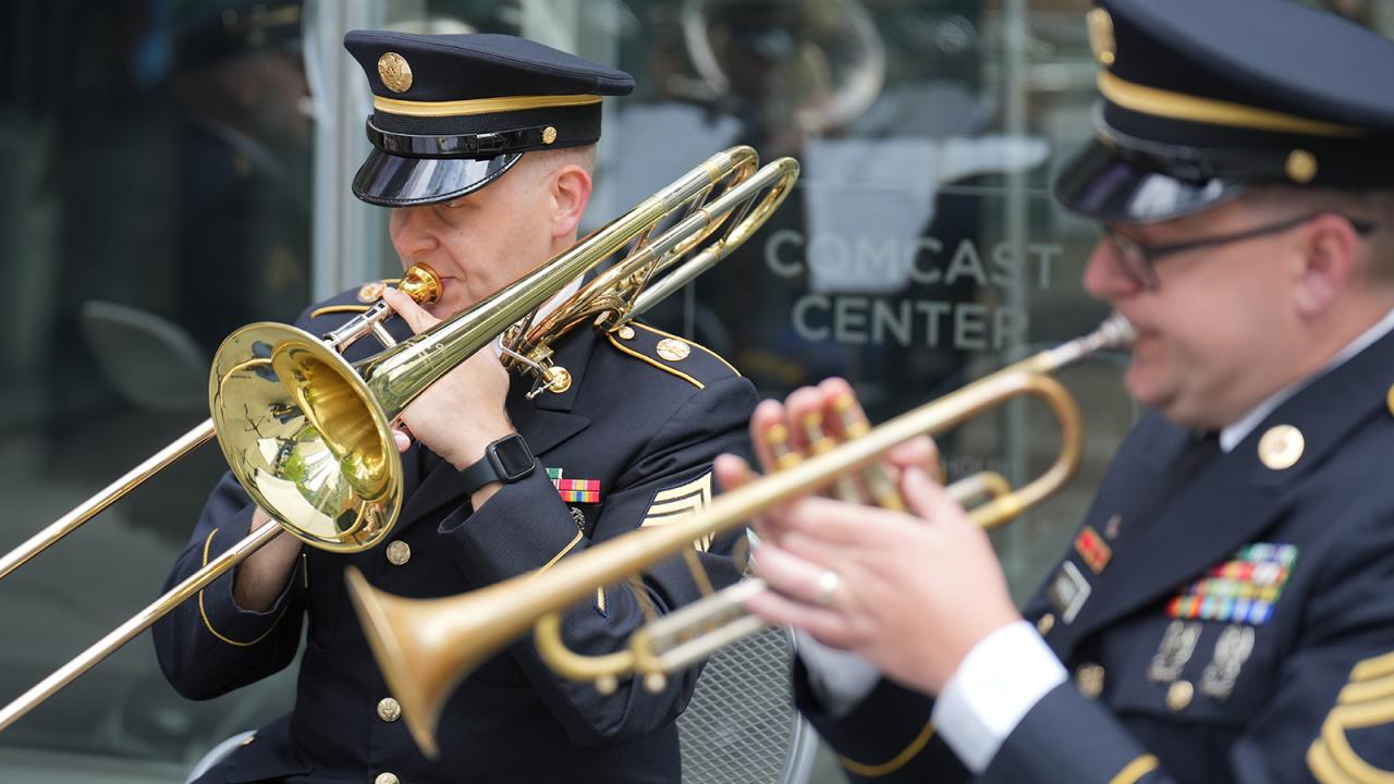 Two members of the armed forces playing brass instruments