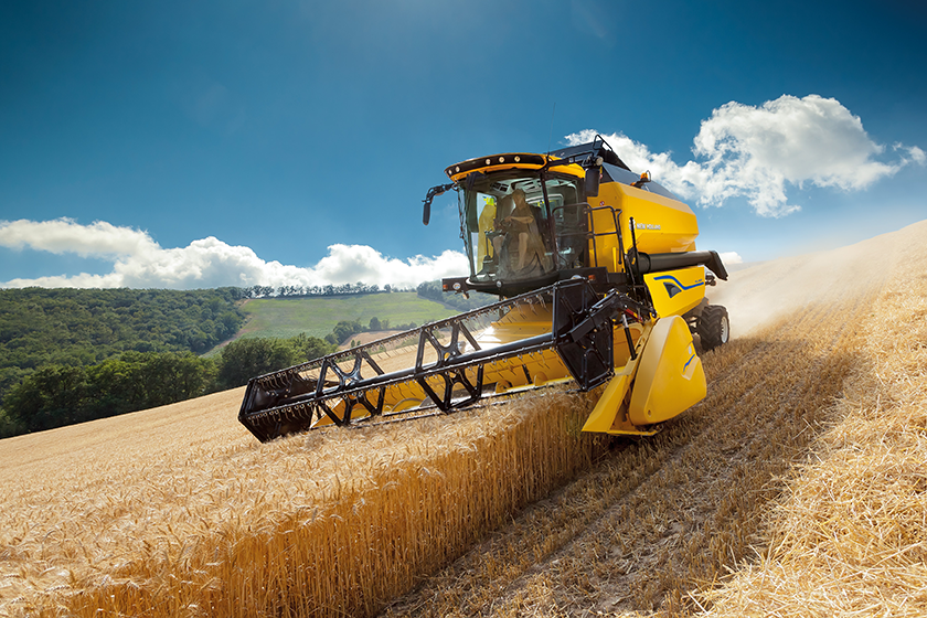 Yellow machine in action in a field