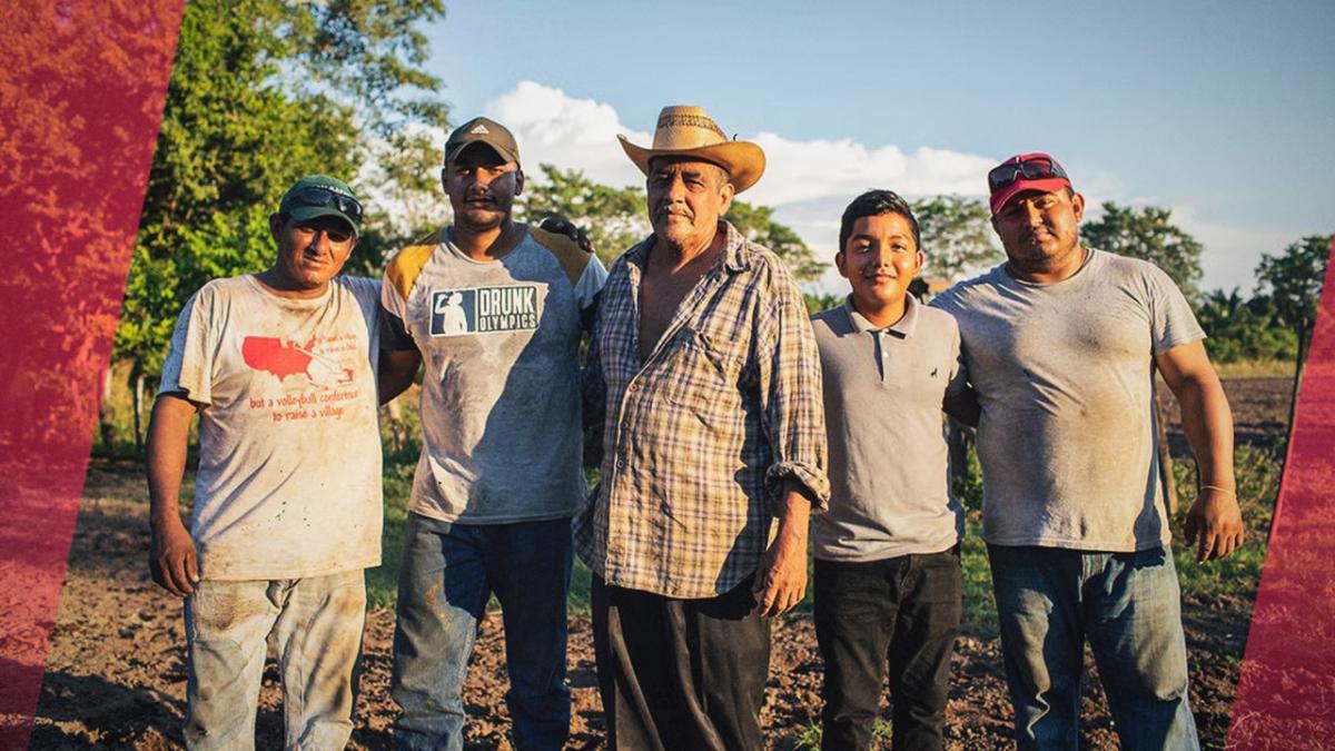 A group of five farmers with arms around each other.