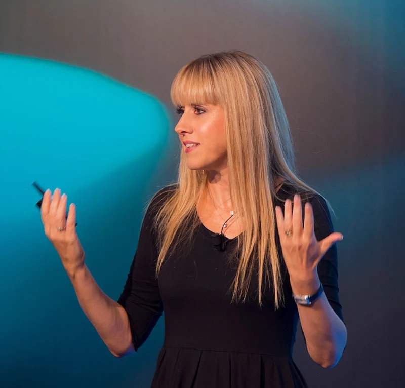 Nicoletta Luppi speaking, with hands raised, looking to her right