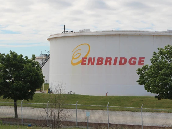 Large outdoor holding tank with Enbridge logo on the side