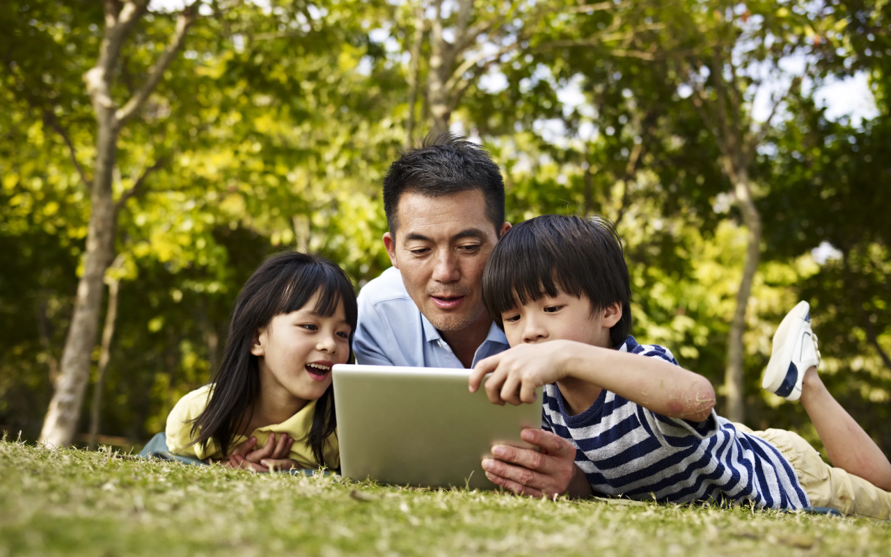 parent and children on a laptop
