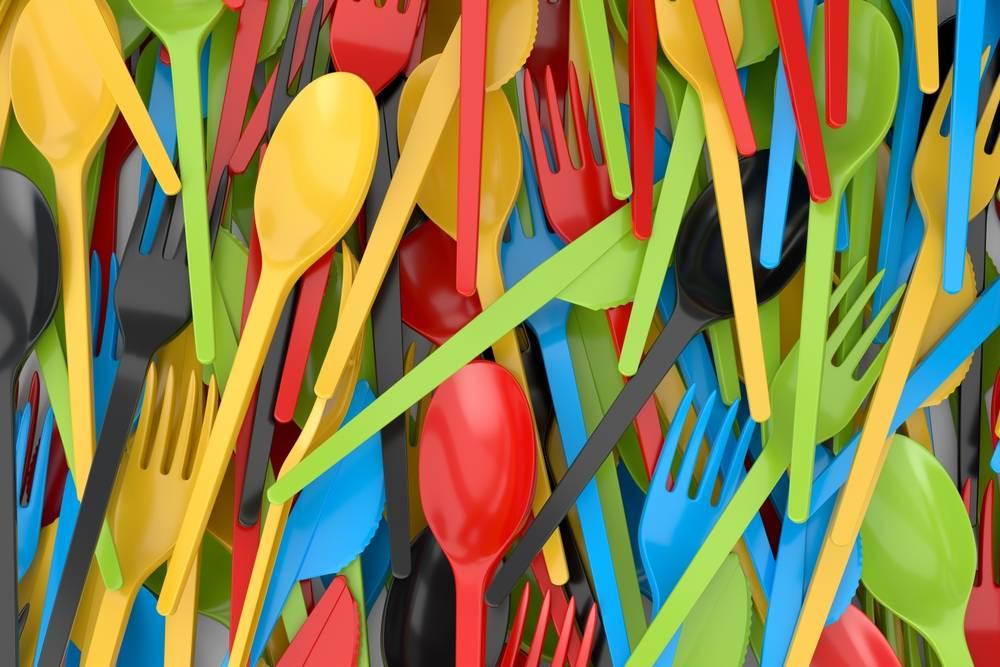 Close up of a pile of colorful plastic cutlery