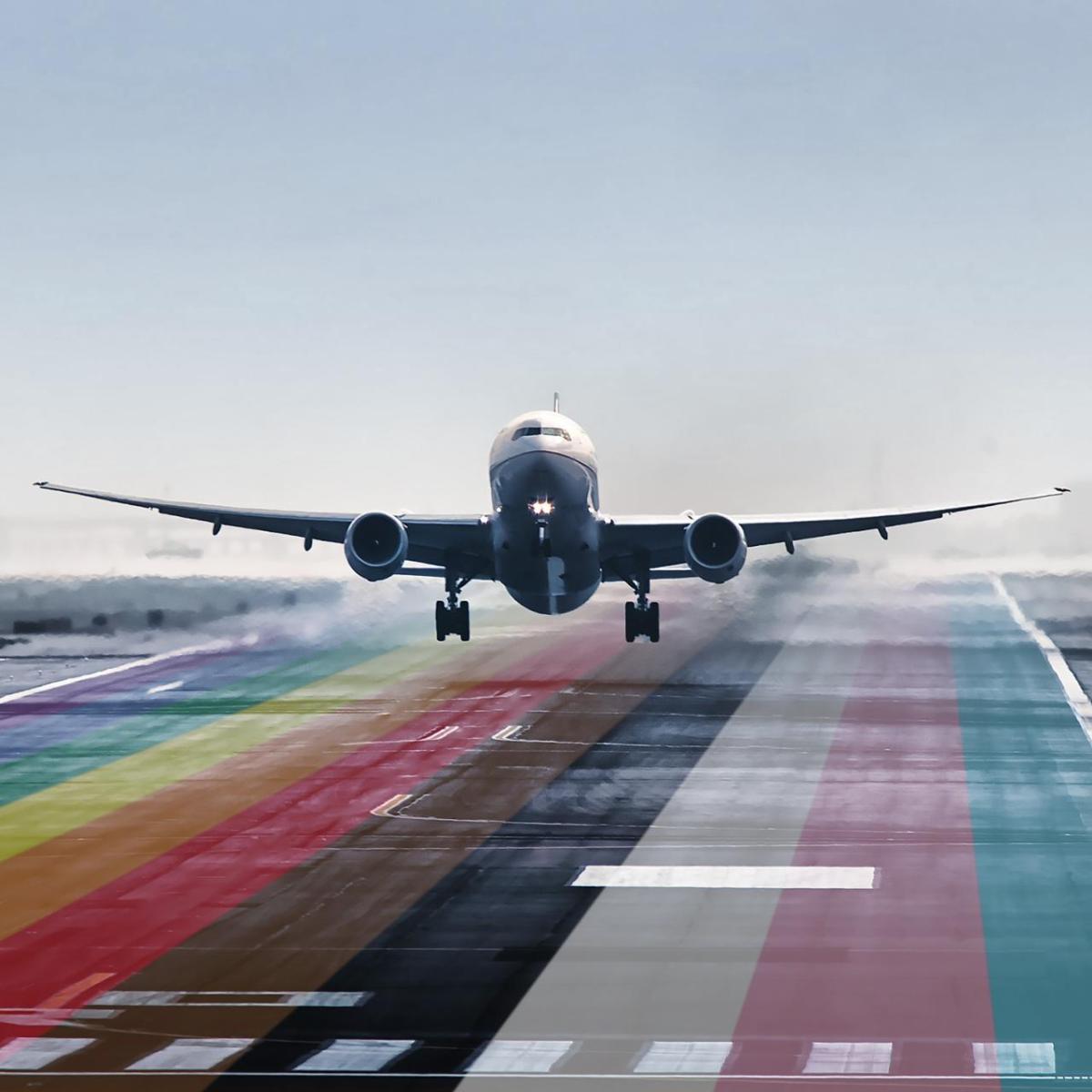 plane taking off from a pride colored runway