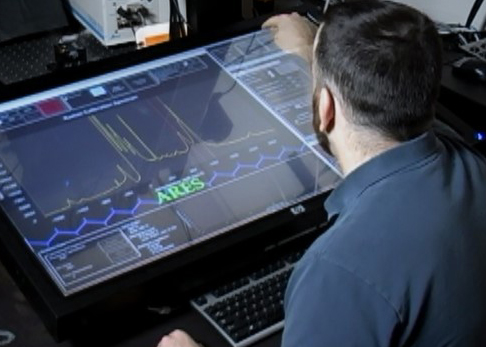 A materials researcher examines experimental data on the an artificial intelligence planner that is part of the DOD's Project Maven. 