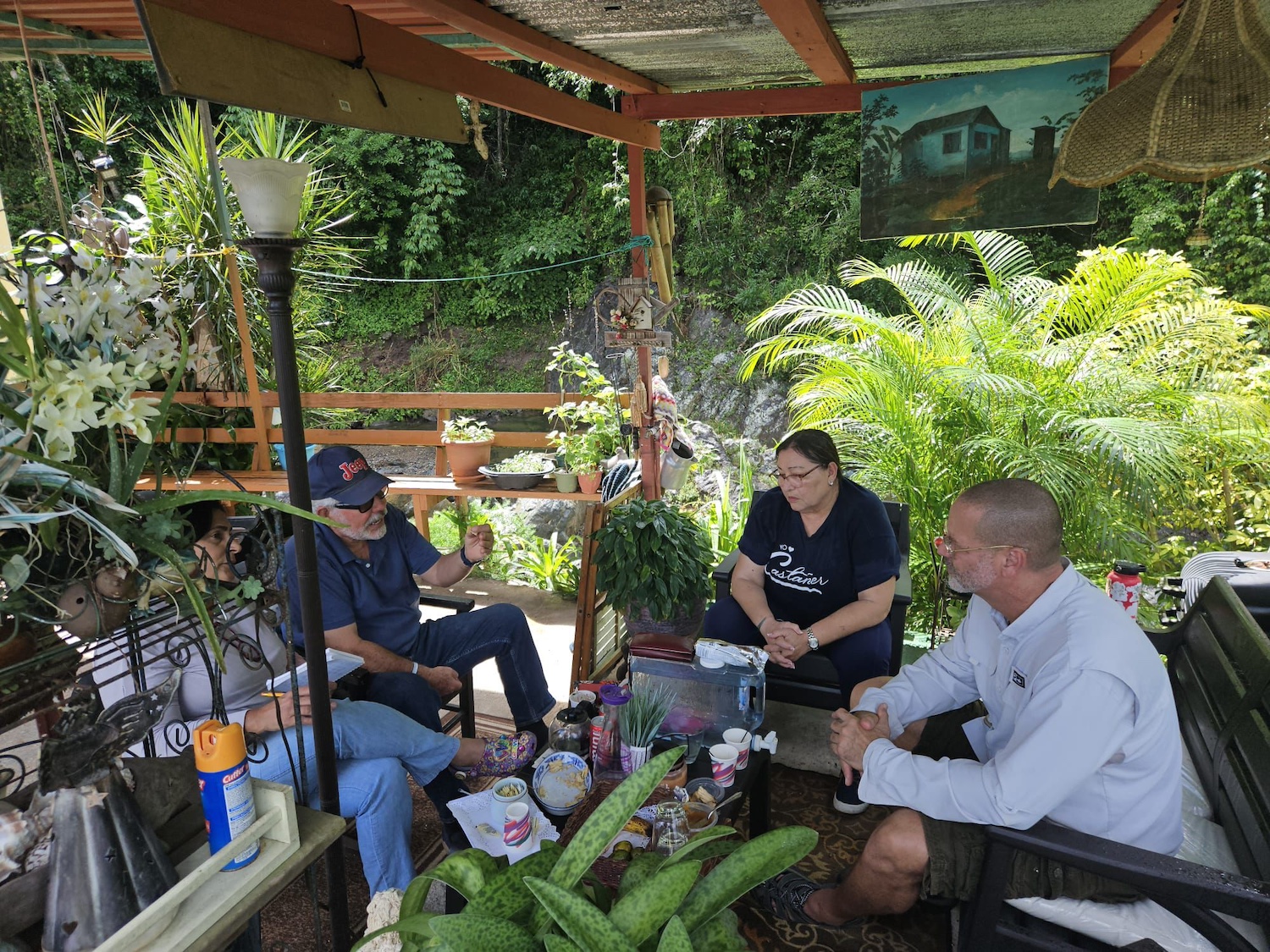 Castañer community members and the Interstate Renewable Energy Council sit together talking over coffee — energy resilience