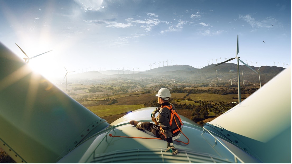 worker sitting on windmill