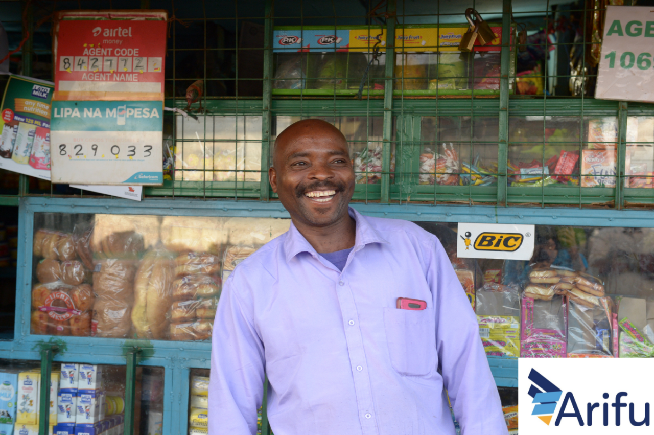 Person standing in front of store. Arifu logo in bottom right corner. 