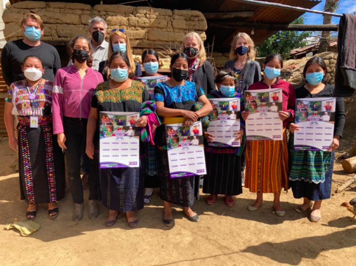 Three staff from Whole Planet Foundation and affiliates of the Kasperick Foundation take a celebratory picture after attending a Friendship Bridge Trust Bank meeting near Panajachel, Guatemala.