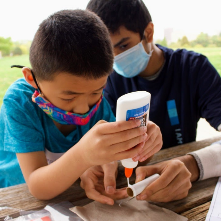 2 students gluing a project