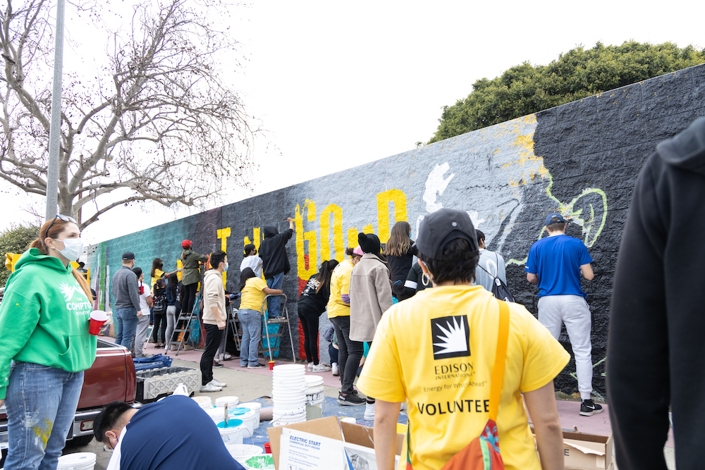 Dozens of volunteers painted a mural featuring the Compton Initiative's motto "Just Do Good."