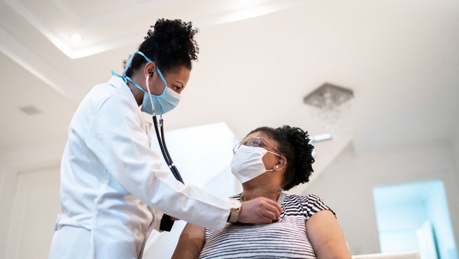 Doctor checking patient's heart