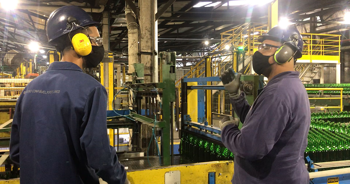 Two factory workers talking in sign language 