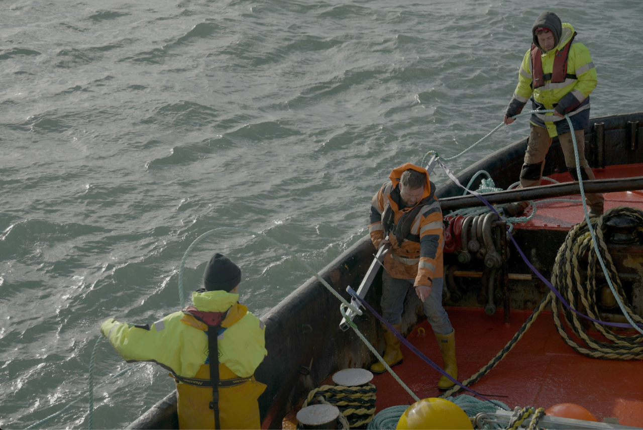 People on a ship place ropes in the water to expand the Blue Forest project in 2023 — aquaculture