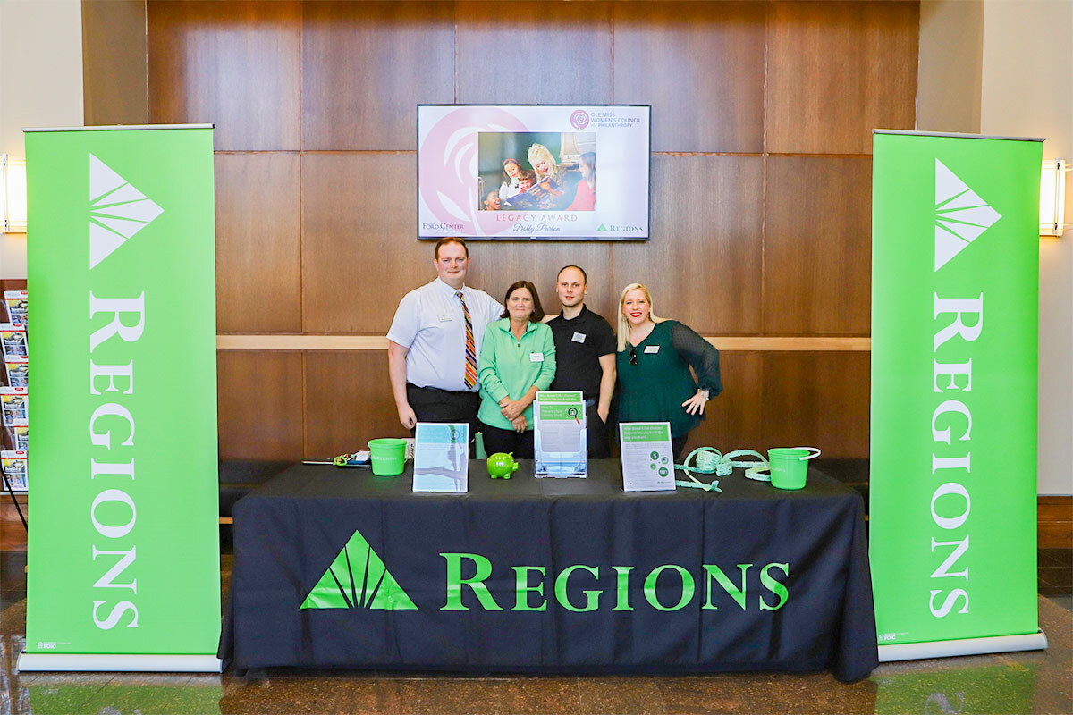 regions booth with four people standing behind it